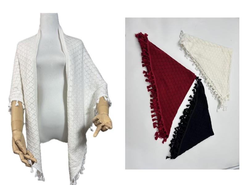 White diamond knit tassel shawl wrap on mannequin with burgundy, black, and white triangle folded shawls on right