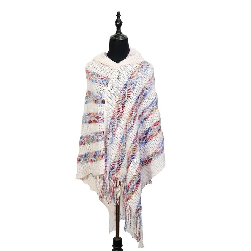 Ivory hooded knit poncho with multicolor red blue striped pattern and fringe hem displayed on black dress form mannequin