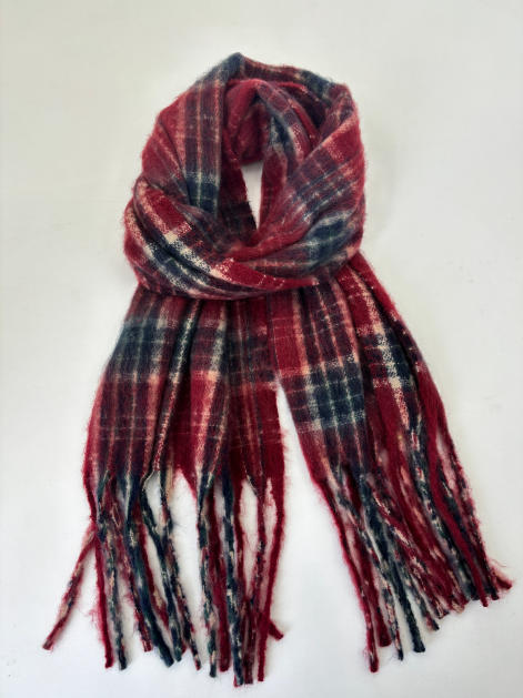 Soft brushed plaid tartan scarf in red, navy, and white with long fringe ends, loosely knotted on white background