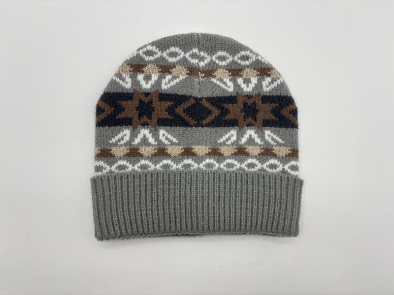 Grey knit beanie hat with Southwestern geometric pattern in brown, navy, cream, and white with ribbed cuff