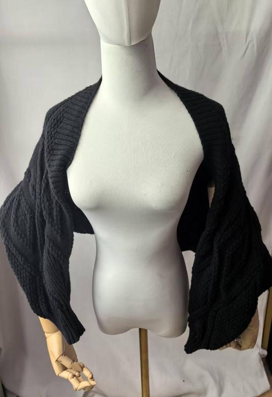 Black chunky cable knit bolero shrug cardigan with wide sleeves displayed on a dress form mannequin