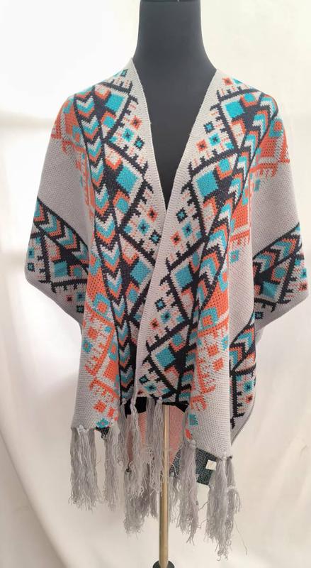 Gray knit kimono cardigan with colorful Aztec geometric pattern in teal, orange, and navy, displayed on mannequin with fringe hem