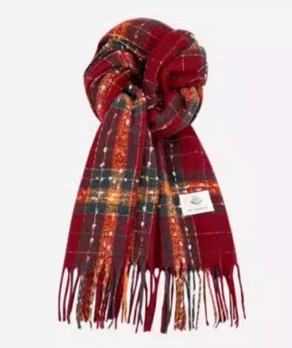Knotted red tartan plaid scarf with green, orange, and gold accents and fringed ends on white background