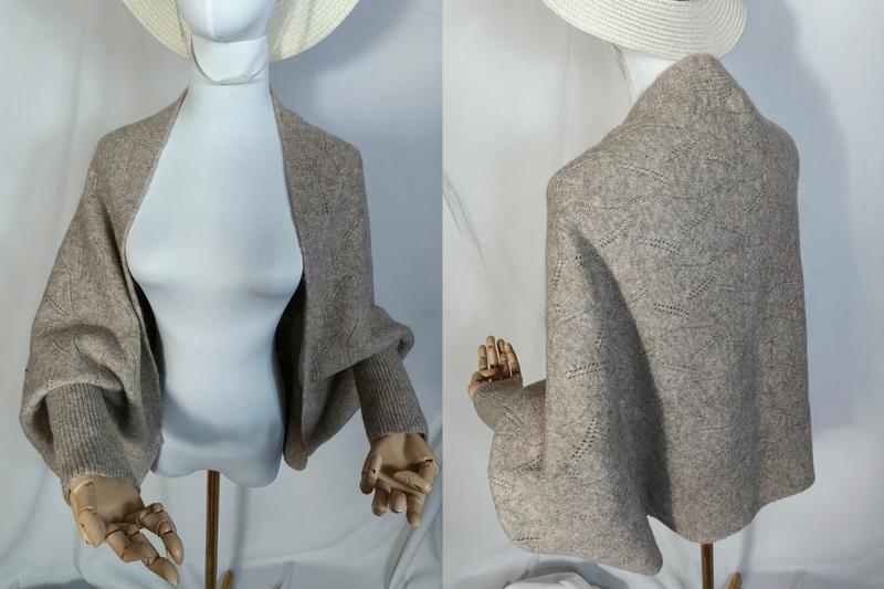Front and back view of a taupe lace-knit open-front cardigan shrug with balloon sleeves and ribbed cuffs on a mannequin