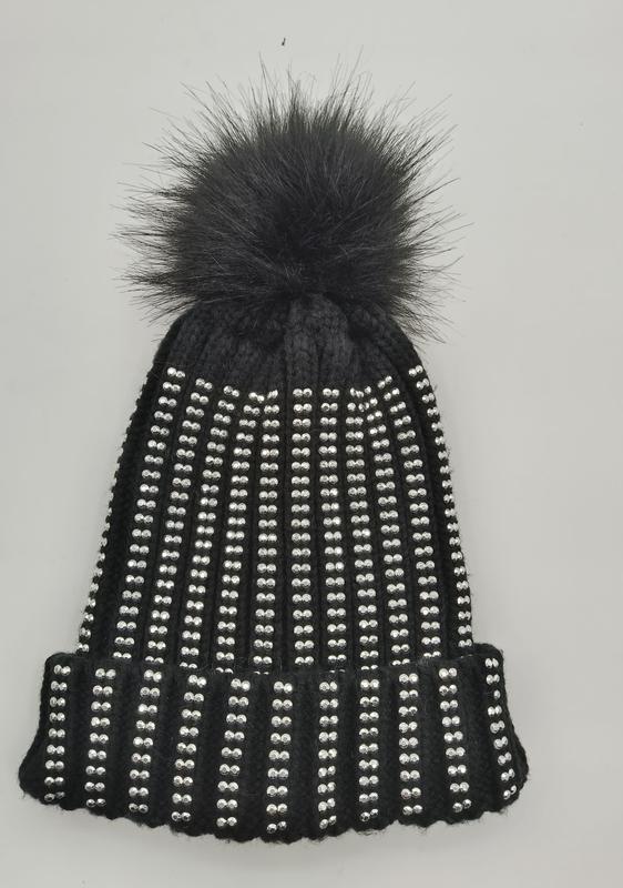 Black ribbed knit winter beanie covered in silver crystal studs with a large black faux fur pom pom on top