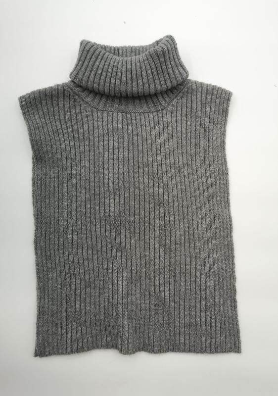 Grey ribbed knit sleeveless turtleneck sweater vest laid flat on white background