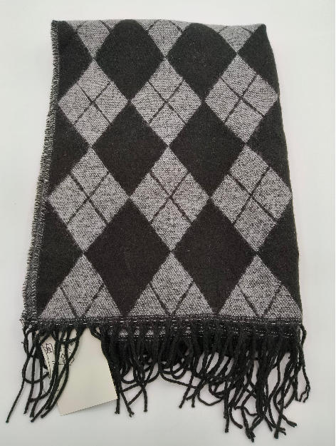 Folded charcoal and grey argyle diamond pattern knit scarf with black tassel fringe edge on white background