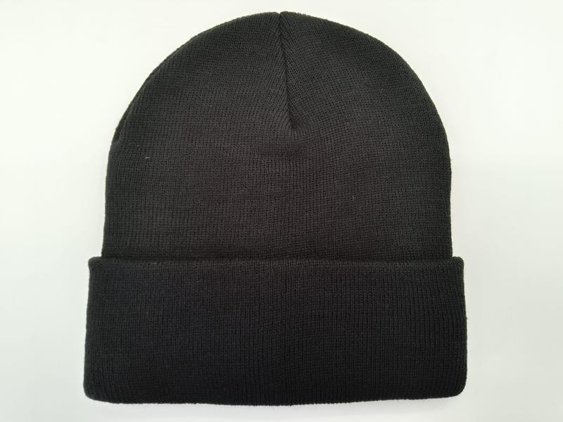 Plain black ribbed knit beanie with folded cuff, laid flat on white background, unisex winter hat