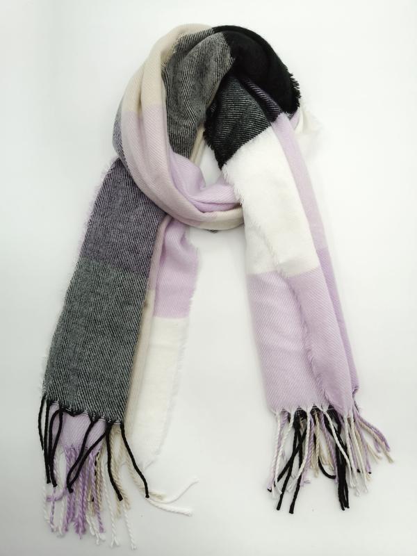 Folded plaid blanket scarf in lavender, white, black and gray with twisted fringe tassels on white background