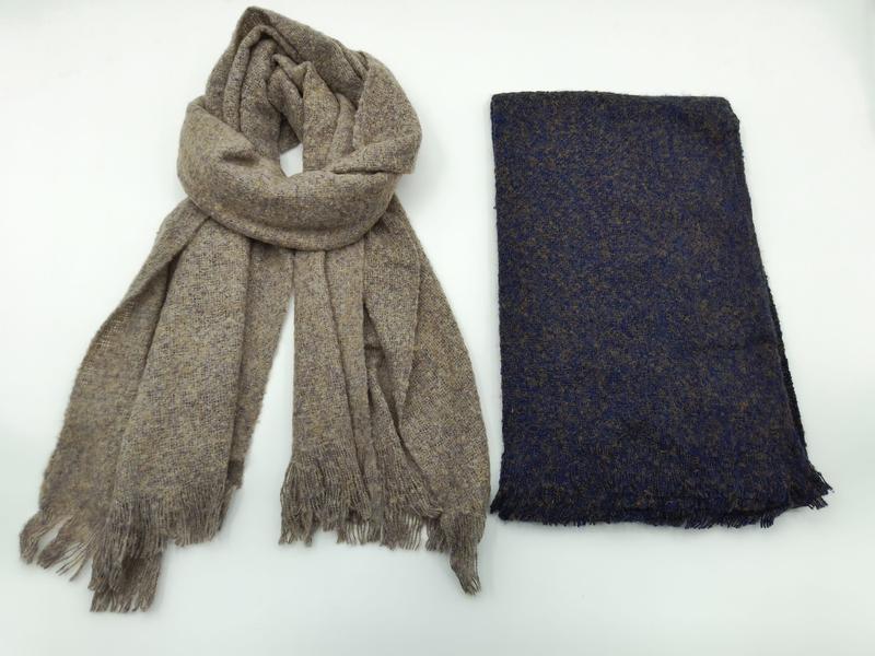 Two woven fringe scarves side by side: draped taupe heathered scarf and folded navy blue tweed scarf on white background