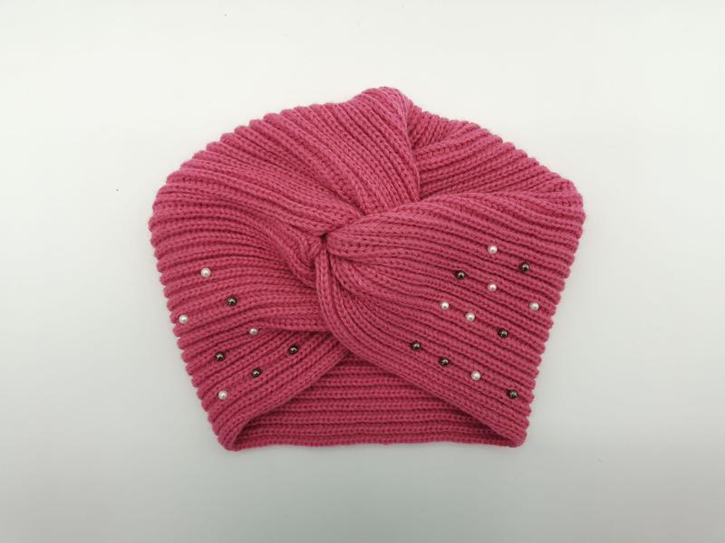 Pink ribbed knit turban-style beanie hat with twisted front knot and scattered white pearl and dark hematite bead embellishments
