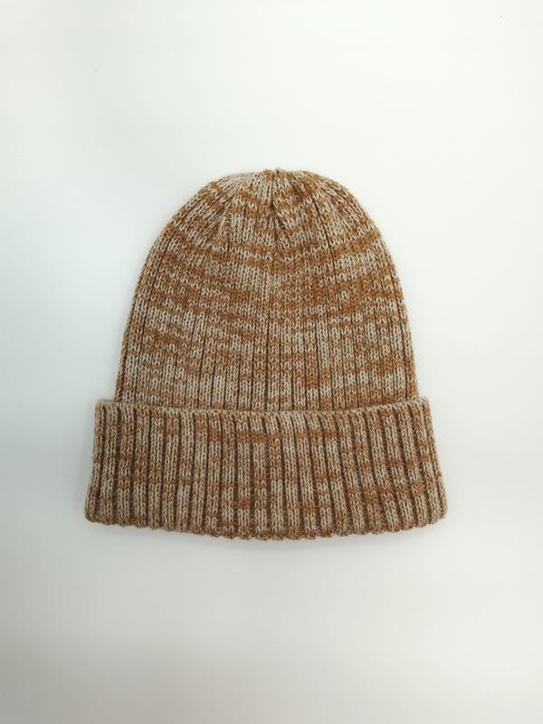 Flat lay of a chunky ribbed knit beanie hat in caramel and cream marl yarn with folded cuff on white background