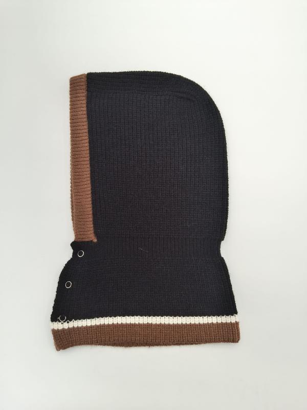Black ribbed knit balaclava hood with brown trim, white stripe accent, and silver snap buttons on white background