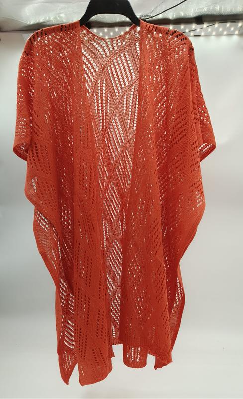 Rust orange open-knit crochet kimono cardigan with geometric lace pattern and short sleeves displayed on hanger