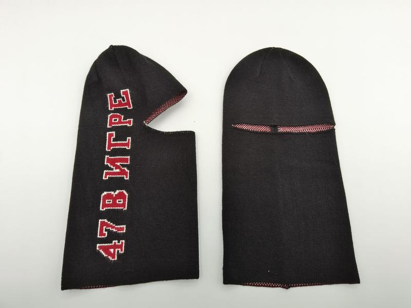 Two black knitted balaclavas shown front and back, one with red Cyrillic '47 В ИГРЕ' lettering, red mesh eye slit lining