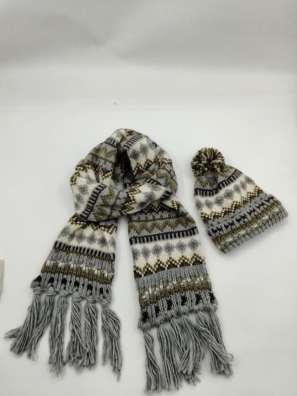 Gray and brown Fair Isle patterned knit scarf with fringe tassels and matching pom-pom beanie hat set on white background