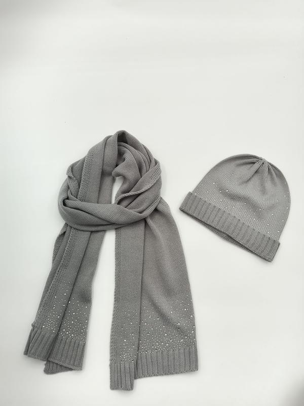 Grey knitted beanie hat and long scarf set with scattered rhinestone crystal details on white background