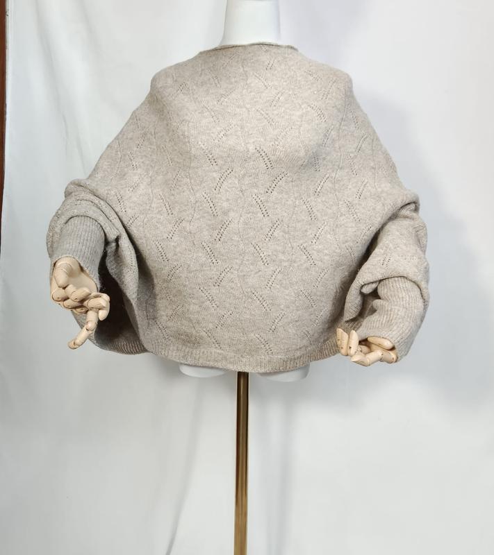 Oversized oatmeal beige pointelle knit sweater with balloon sleeves displayed on a mannequin with wooden artist hands