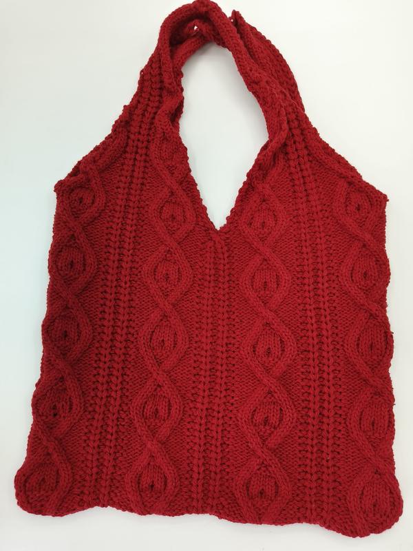 Red cable knit tote bag with braided pattern and single shoulder strap on white background