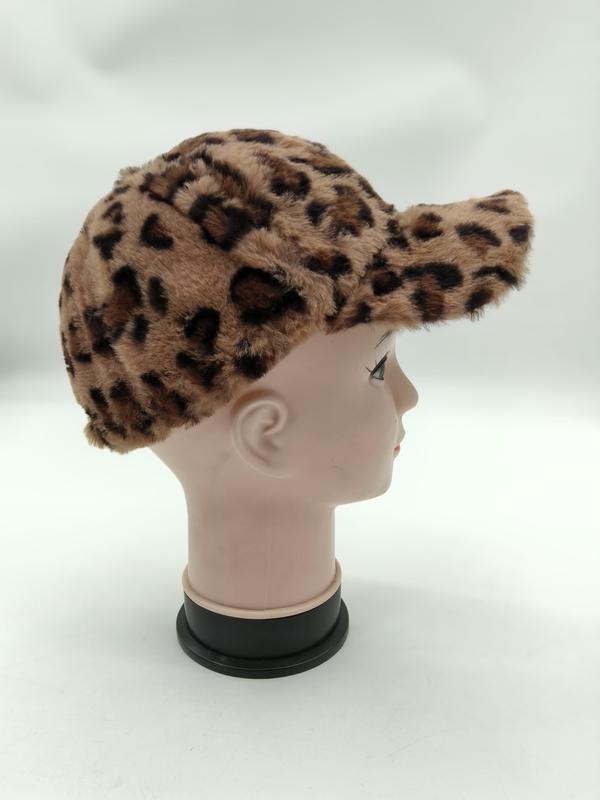 Leopard print faux fur baseball cap displayed on a mannequin head, side profile view, beige and brown animal pattern