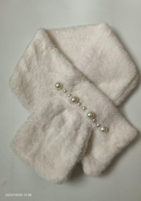 White fluffy faux fur crossover neck scarf decorated with graduating pearl beads arranged diagonally across the front
