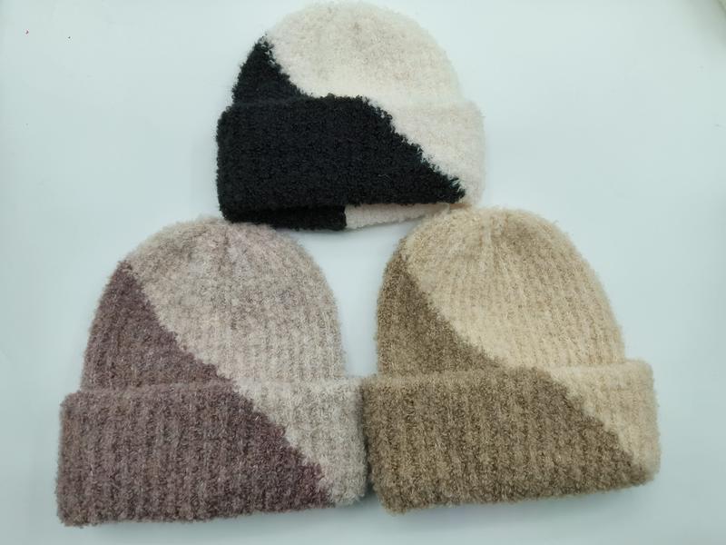Three two-tone colorblock knit beanies in black-cream, mauve-blush, and tan-khaki with ribbed cuff, displayed on white background