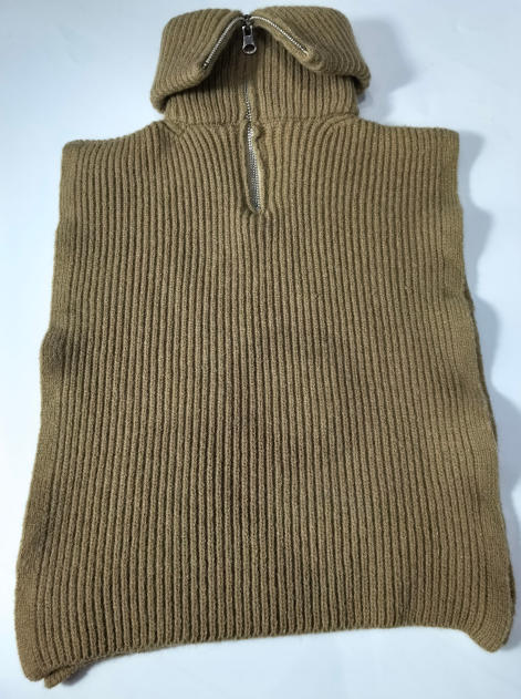 Camel tan ribbed knit sleeveless poncho vest with half-zip collar, laid flat on white background