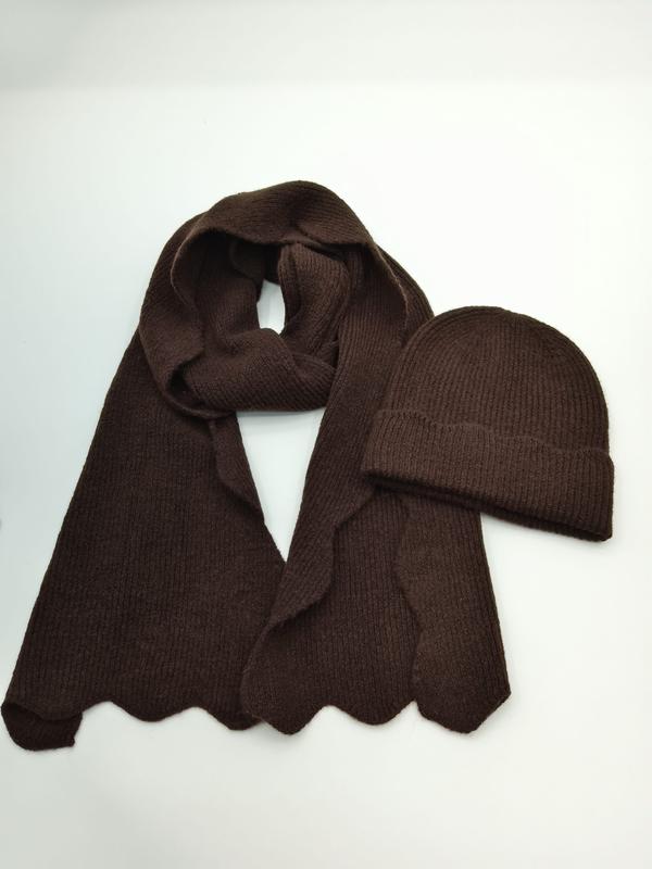 Dark chocolate brown ribbed knit winter scarf with scalloped hem and matching beanie hat set on white background
