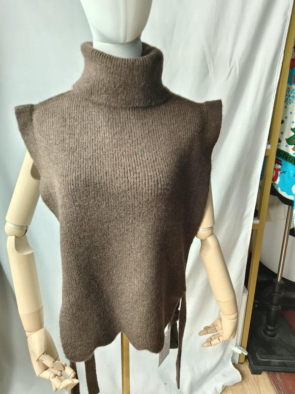 Taupe brown sleeveless turtleneck knit sweater vest with side tie details displayed on a mannequin