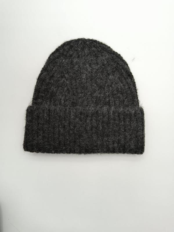 Dark charcoal grey chunky ribbed knit beanie hat with folded cuff, flat lay on white background