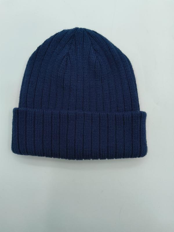 Navy blue ribbed knit winter beanie hat with folded cuff, laid flat on white background